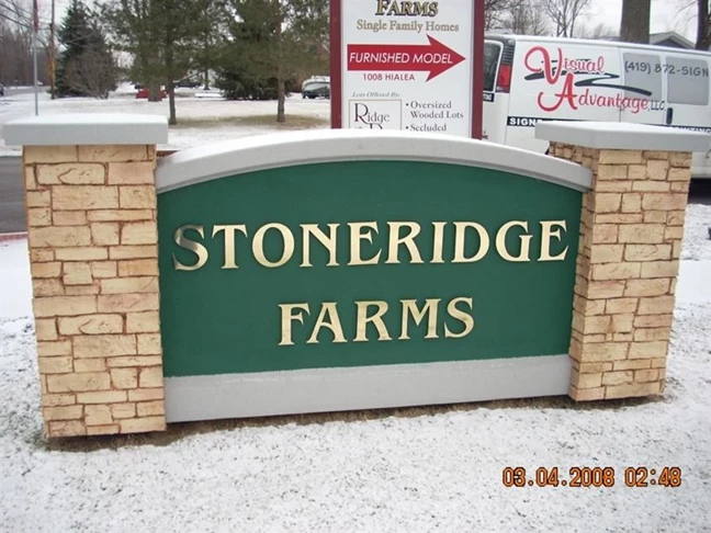 Monument sign with texture plus decorative stone. The lettering is gold mirror sheeted acrylic raised letters. This sign in installed in Sylvania, Ohio.